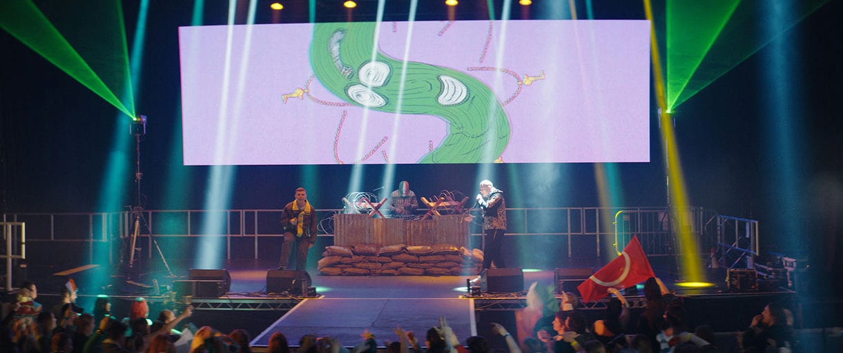 The band Kneecap playing on stage in the film Kneecap