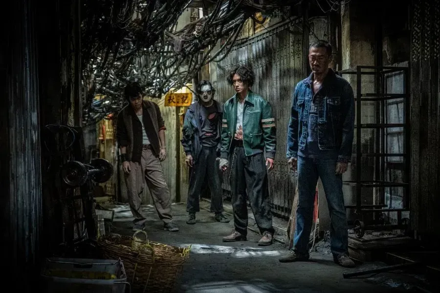 The cast of Twilight of Warriors stand in a dark alley